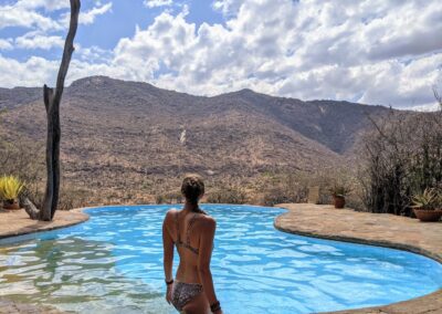 A lady at a pool over looking samburu