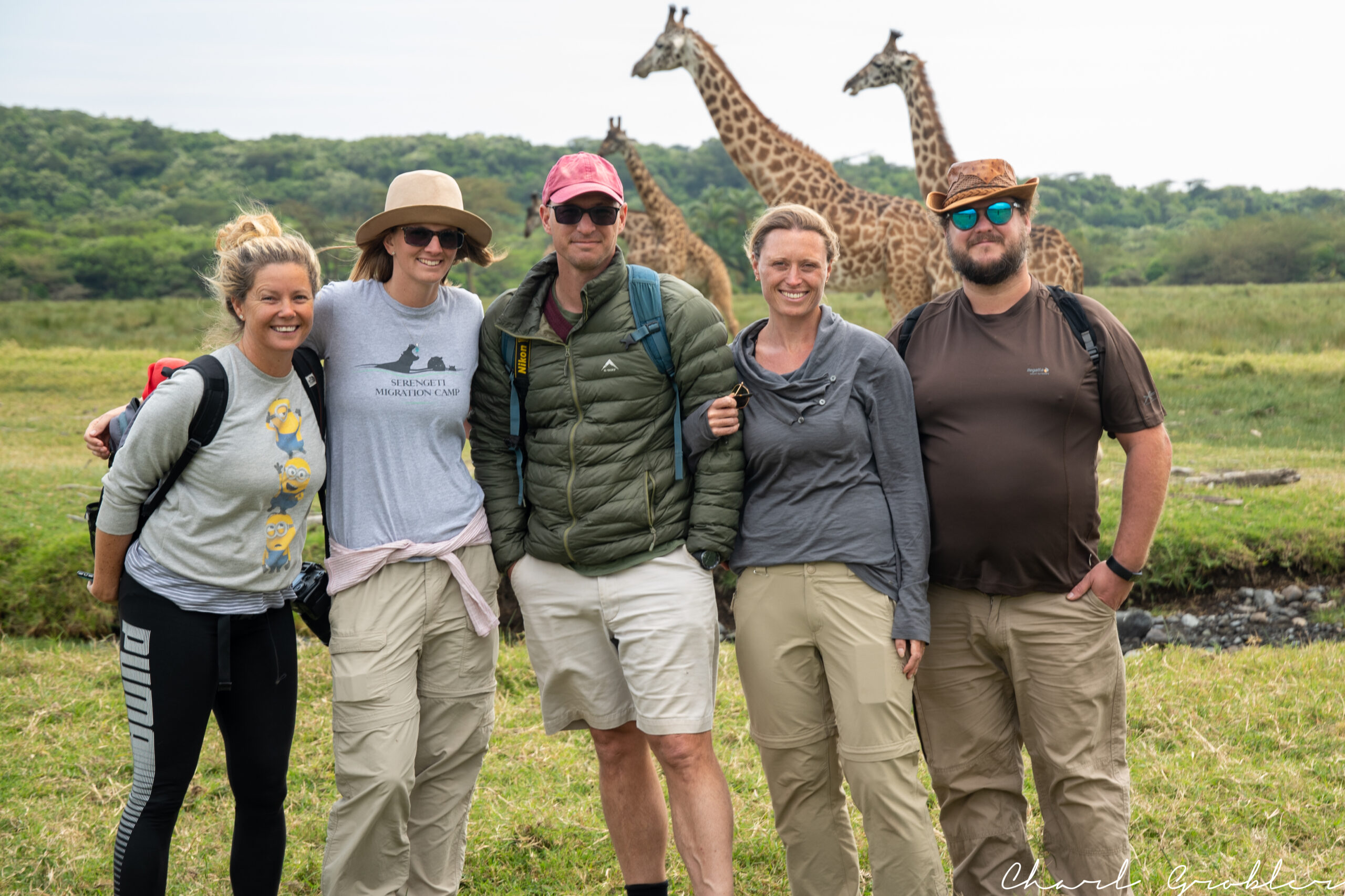 a group standing in front of wild giraffe in Tanzania 